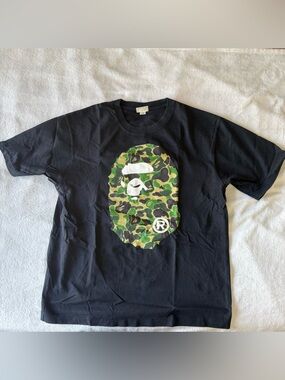 A Bathing Ape (BAPE) Black Tee with Signature Ape Head Tag